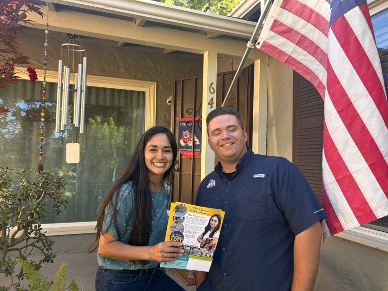 Ariana talking with a District 7 resident on the doorstep of his home while canvassing