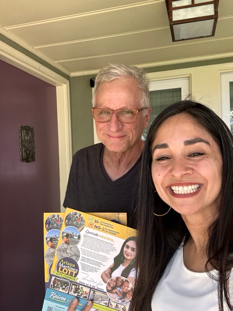 Ariana standing with a District 7 neighbor who is holding campaign literature